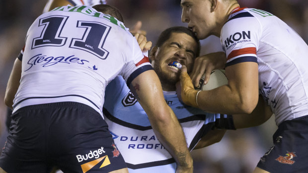 Up close and personal: Braden Hamlin-Uele  takes on the Roosters defence..