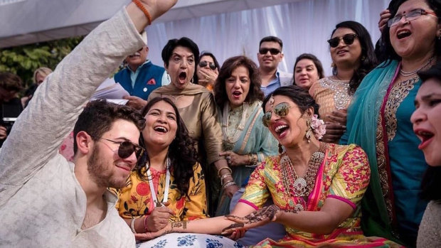 Bollywood actress Priyanka Chopra and Nick Jonas celebrate during a mehendi ceremony, a day before their wedding.