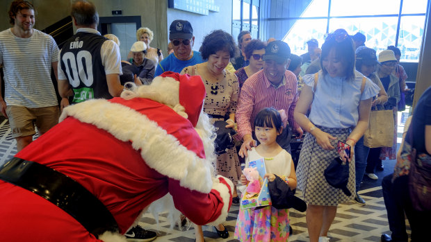 Cindy Lu, 5, meets Santa.