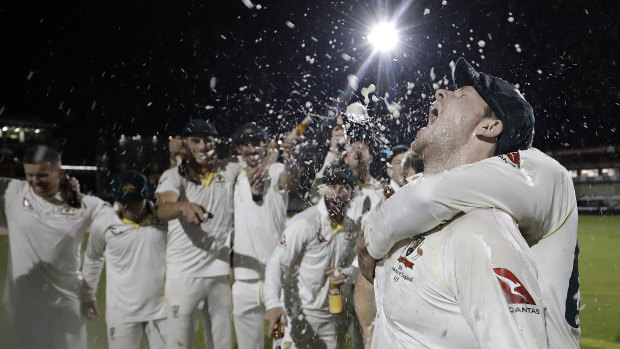 Australian players celebrate retaining the Ashes at Old Trafford.