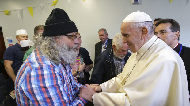 Pope Francis greets Aidan Walsh during a visit to the Capuchin Day Centre on Bowe Street in Dublin, as part of his visit to Ireland, on Saturday.