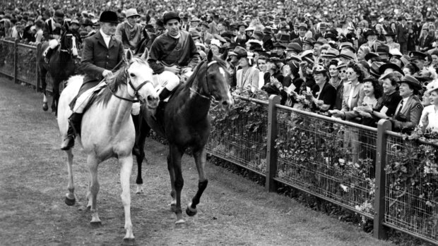 Darby Munro, still regarded by many as Australia's greatest jockey, and Russia parade after winning the 1946 Melbourne Cup.