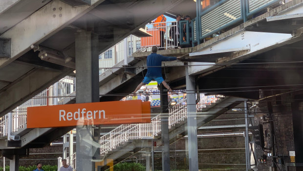 Serious situation: A man climbs on the the power lines at Redfern station.