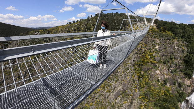 A woman walks across the footbridge in Arouca, northern Portugal.