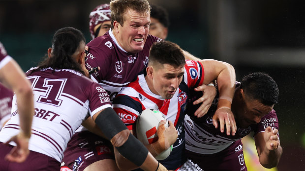 Roosters forward Victor Radley tries to evade Manly’s Jake Trbojevic and teammates.