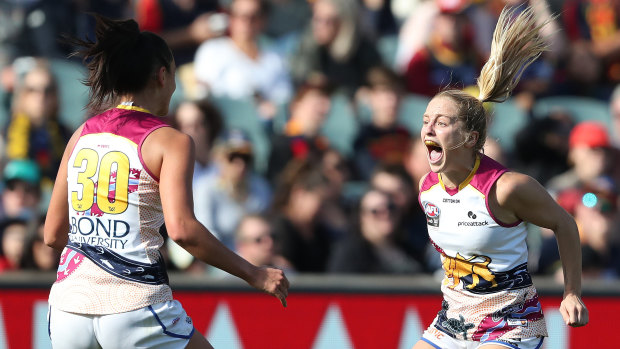 That winning feeling: Isabel Dawes and Lions teammate Jesse Wardlaw celebrate a goal during the 2021 AFLW grand final at Adelaide Oval.