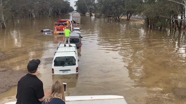 A line of cars in floodwaters on the Hume Freeway near Wangaratta on Thursday.