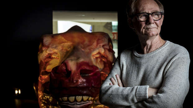 Artist Ivan Durrant with his sculpture of a skinned cow's head at the National Gallery of Victoria Australia.