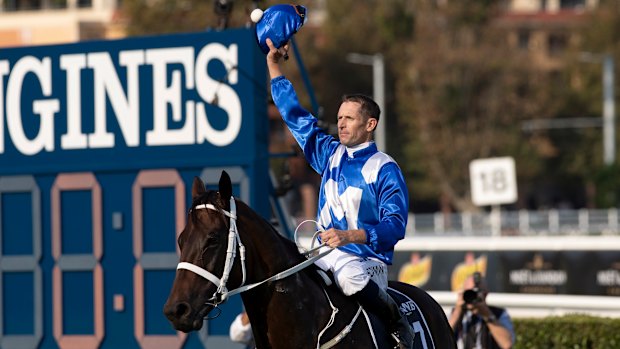 Hugh Bowman salutes the crowd after winning on Winx at Randwick.