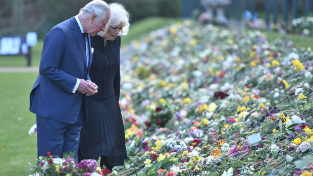 Prince Charles and Camilla, the Duchess of Cornwall, inspect flowers left for Prince Philip. 