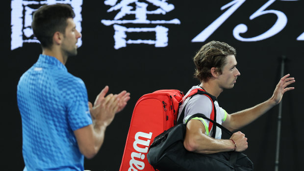 Novak Djokovic applauds as Alex de Minaur leaves Rod Laver Arena.