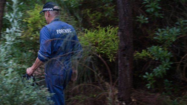 Police in the scrubland where Joanne Martell's body was found.