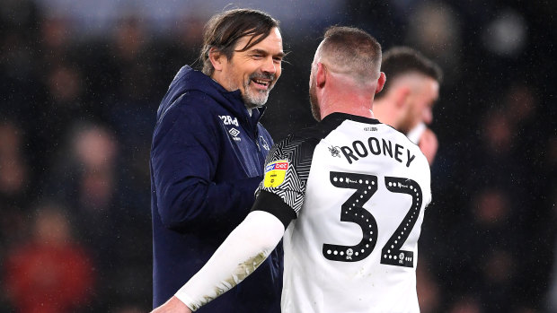 Rooney wearing the controversial No.32 shirt with Phillip Cocu, manager of Derby County.