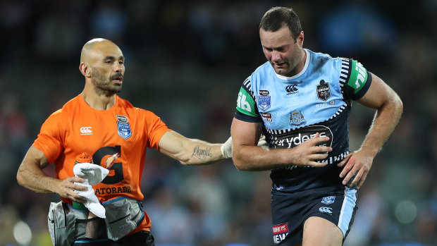Boyd Cordner is assisted off Adelaide Oval for a head injury assessment.