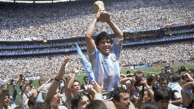 Diego Maradona holds the trophy aloft.