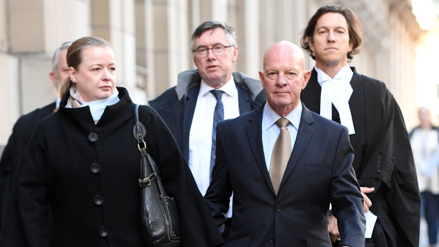 Clifford John Gerathy (second from right) leaves the Supreme Court in Melbourne on Friday.