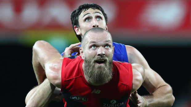 Eyes on the prize: Max Gawn gets front spot in a ruck contest against Oscar McInerney of the Lions.