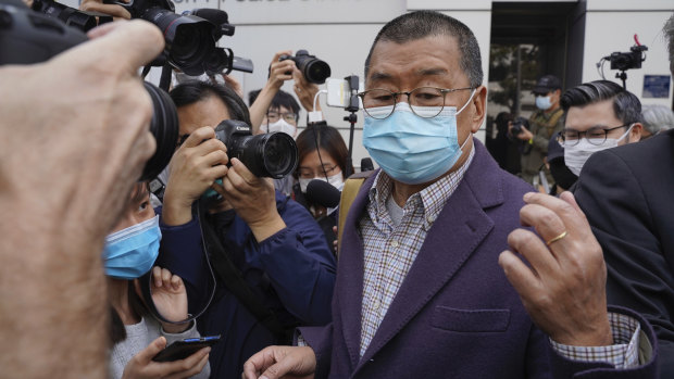 Founder of Hong Kong's Apple Daily newspaper, Jimmy Lai, walks out from a police station after being bailed out in Hong Kong.