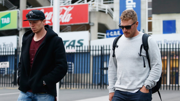 Peter Siddle and Aaron Flinch leave the SCG after the death of Phillip Hughes on November 27, 2014.