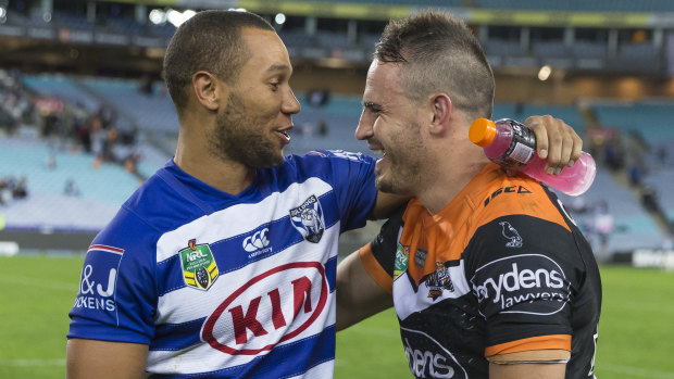 Teammates again: Moses Mbye speaks with Josh Reynolds after Canterbury's match against the Tigers on Sunday.