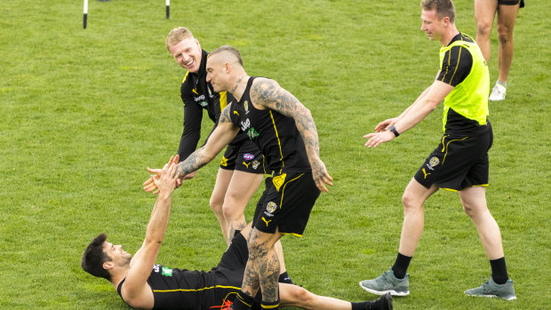 All for one: Dustin Martin, Josh Caddy and Trent Cotchin in training at Punt Road on Sunday ahead of their preliminary final against Geelong. 