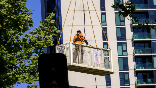 A man is seen being carried into the air above the construction site on Lonsdale Street. 
