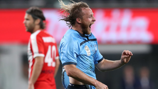 Grabbing the glory: Sydney FC's Ryan Grant celebrates his extra-time winner against Melbourne City.