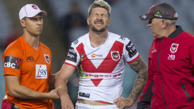 Injury to insult: Gareth Widdop is escorted off the field.