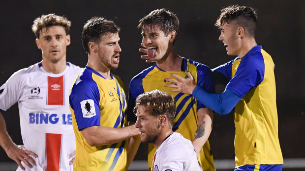 Matt Richardson celebrates with Brisbane Strikers teammates after scoring the winning goal against Manly United.