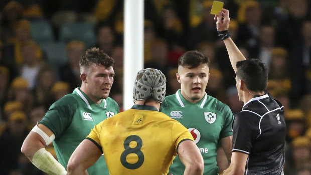 Bewildered: Ireland and Australia captains watch on as Jacob Stockdale is shown a yellow card