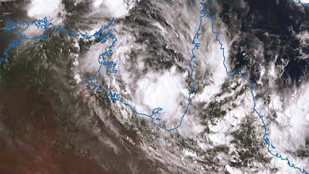 A satellite image a captured on Saturday afternoon shows a slow-moving tropical low that threatens to develop into Cyclone Esther in the Gulf of Carpentaria near the Northern Territory-Queensland border.