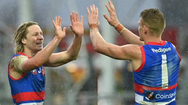 Cody Weightman is congratulated by Adam Treloar after kicking a goal against Essendon in the elimination final.