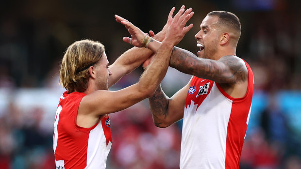 James Rowbottom and Lance Franklin celebrate the match-sealing goal in yesterday’s nine-point victory over the Saints.
