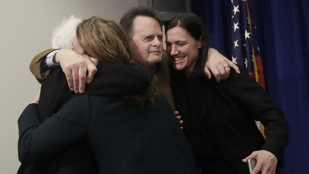Edwin Hardeman, centre, and his wife Mary, left, hug attorneys Jennifer Moore, second from left, and Aimee Wagstaff 