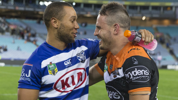 Remember me: Moses Mbye with Josh Reynolds after the latter's Tigers beat the Bulldogs on Sunday.