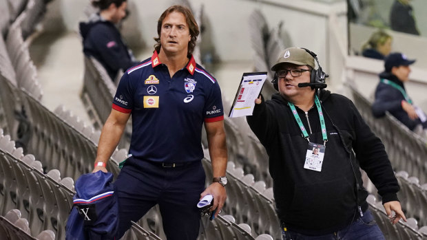 Lost Dog: Luke Beveridge gets help finding his way back to the coaches' box at Marvel Stadium.
