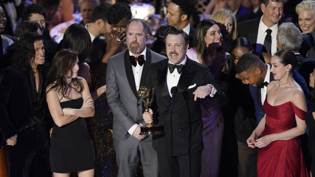 Jason Sudeikis, centre, and the cast of Ted Lasso accept the Emmy for outstanding comedy series at the 2022 Emmy Awards. 