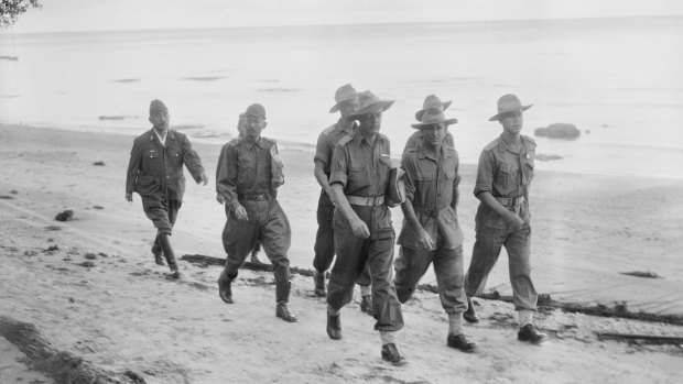 Capt Russell Brereton (centre, light belt) in Labuan, 1945.