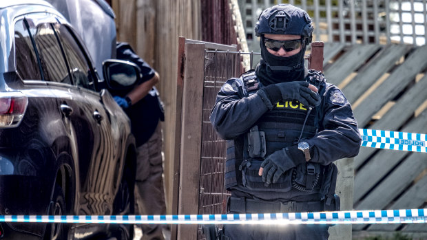 Police stand guard outside the house of Shire Ali's family home in Werribee in November 2018.