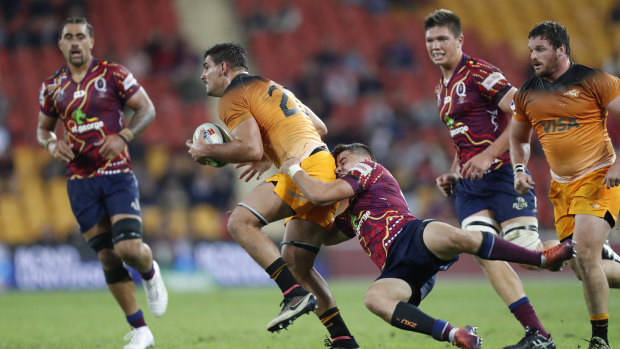 Matt McGahan (right) of the Reds tackles Pablo Matera of Jaguares during the round 16 clash at Suncorp Stadium on Saturday.