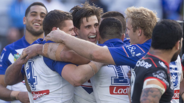 Fairytale match: Lewis is mobbed after scoring a try.