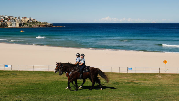 Mounted police patrolling an empty Bondi Beach.