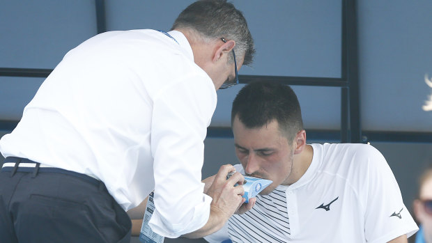 Australian Bernard Tomic using inhaler medication during his match on Tuesday.