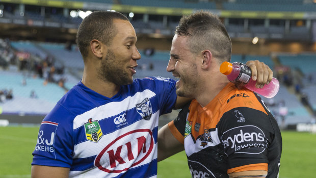 Welcome aboard: Moses Mbye speaks with Josh Reynolds after Canterbury's match against the Tigers on Sunday.