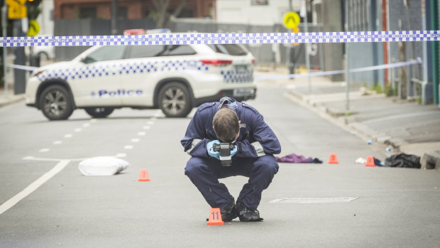 An officer photographs evidence left at the scene.