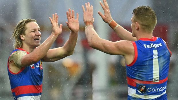 Cody Weightman of the Bulldogs is congratulated by Adam Treloar.