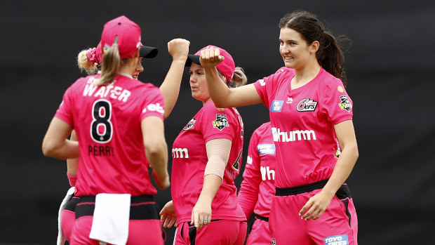 Stella Campbell, right, enjoys a wicket with the Sixers.