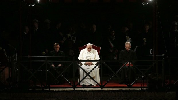 Pope Francis presides over the Via Crucis (Way of the Cross) torchlight procession on the Good Friday in front of ancient Colosseum in Rome.