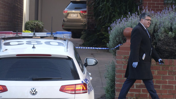 Police at the South Melbourne property where Ms Price's body was found.