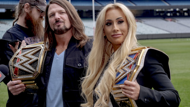 Styles and Carmella with their wrestling trophies.
